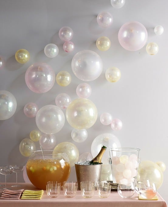 Blow up a few balloons in assorted sizes and tape them to the wall