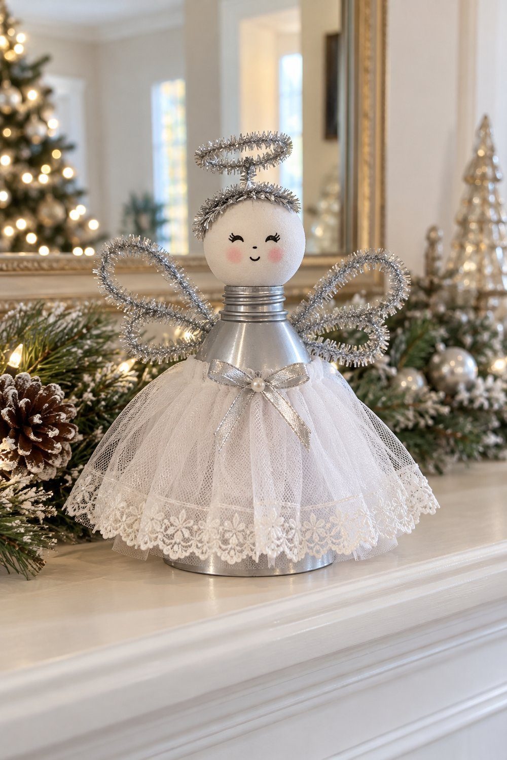 Christmas decorations made from plastic bottles Silver bottle-top angel with tulle skirt standing beside Christmas greenery